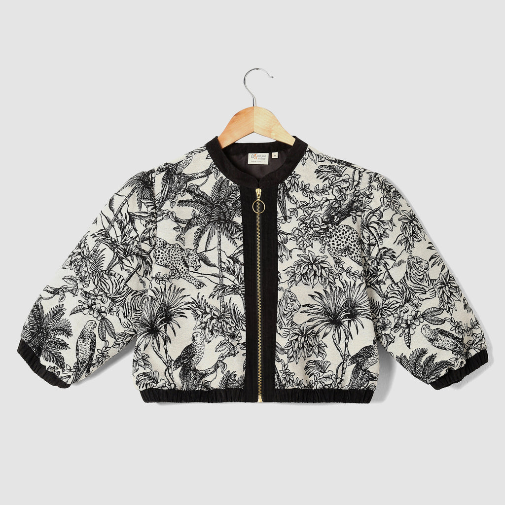 Jacket with black and white floral pattern on a hanger against a light gray background