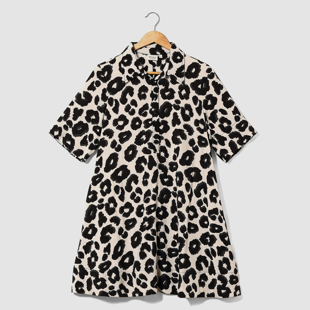Leopard print dress on a hanger against a light gray background
