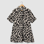 Leopard print dress on a hanger against a light gray background
