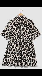 Leopard print dress on a hanger against a light gray background