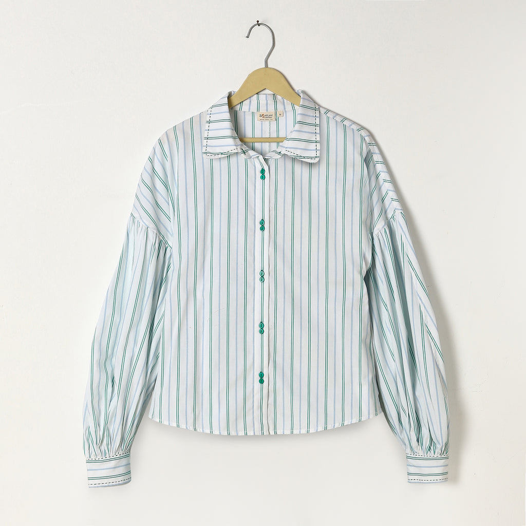 Striped shirt on a hanger against a white background