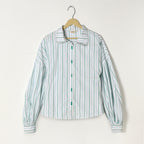 Striped shirt on a hanger against a white background