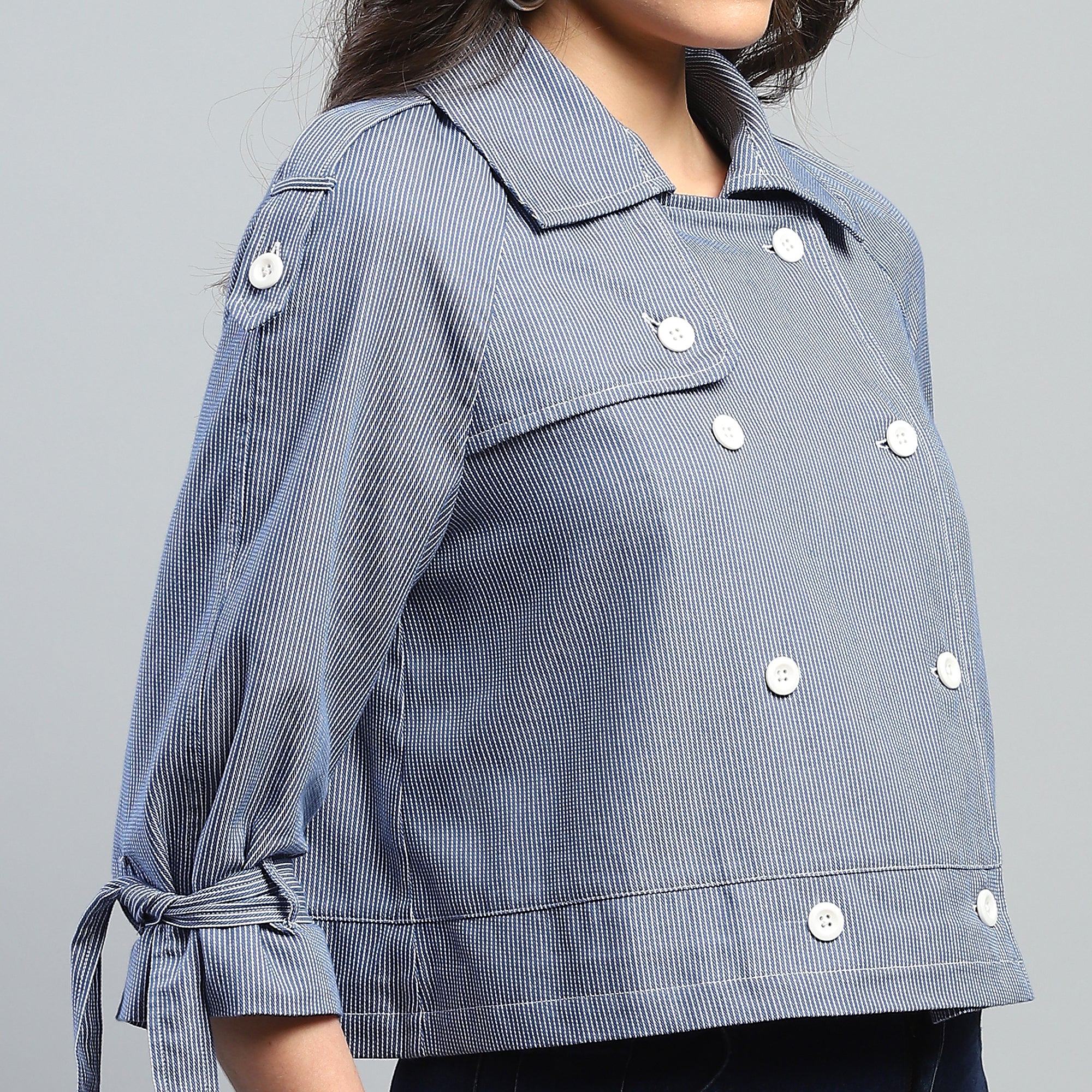 Blue checkered jacket with white buttons on a gray background