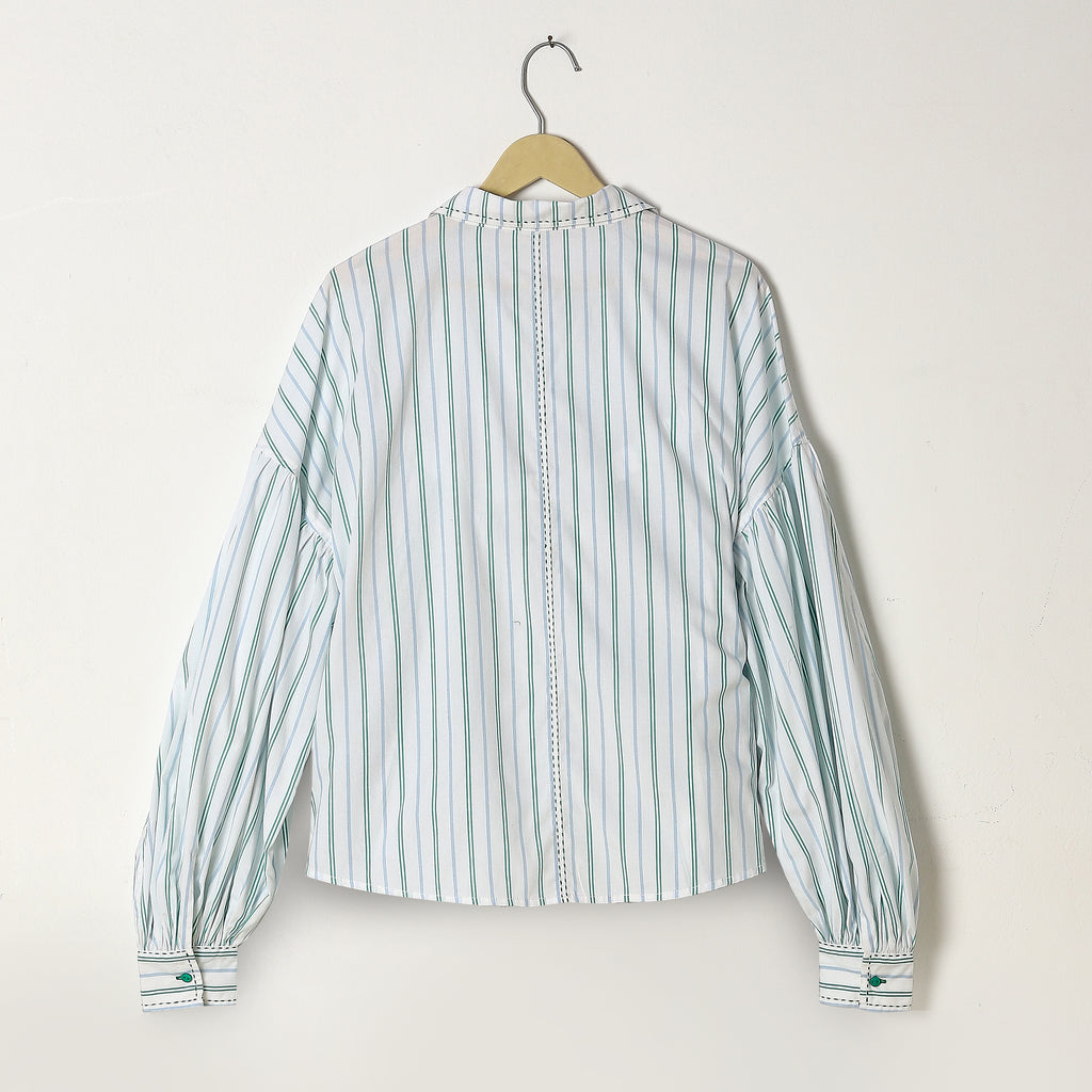 Striped shirt on a hanger against a white background