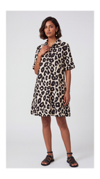 Woman wearing a leopard print dress on a white background