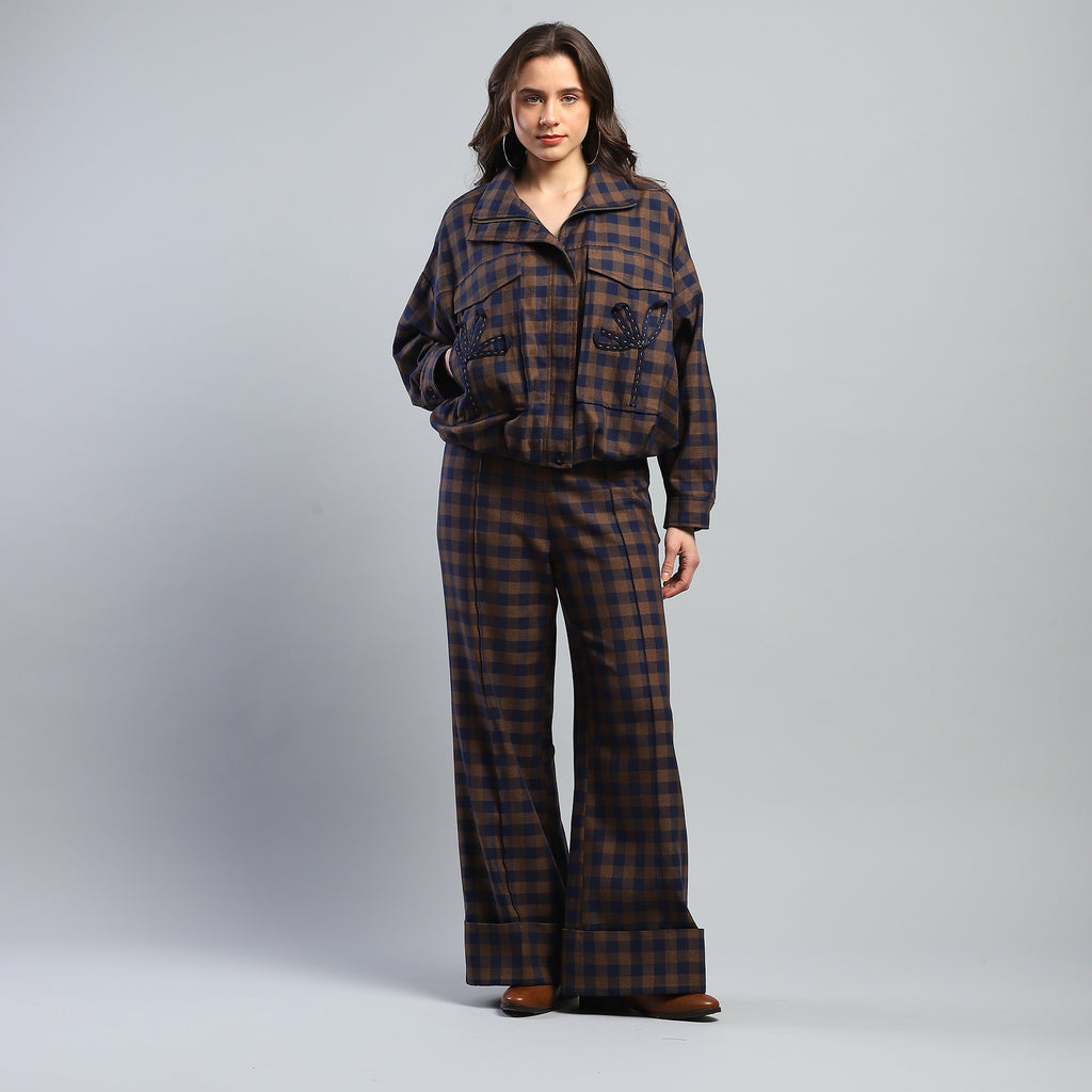 Person wearing a plaid outfit on a gray background