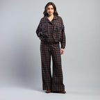 Person wearing a plaid outfit on a gray background