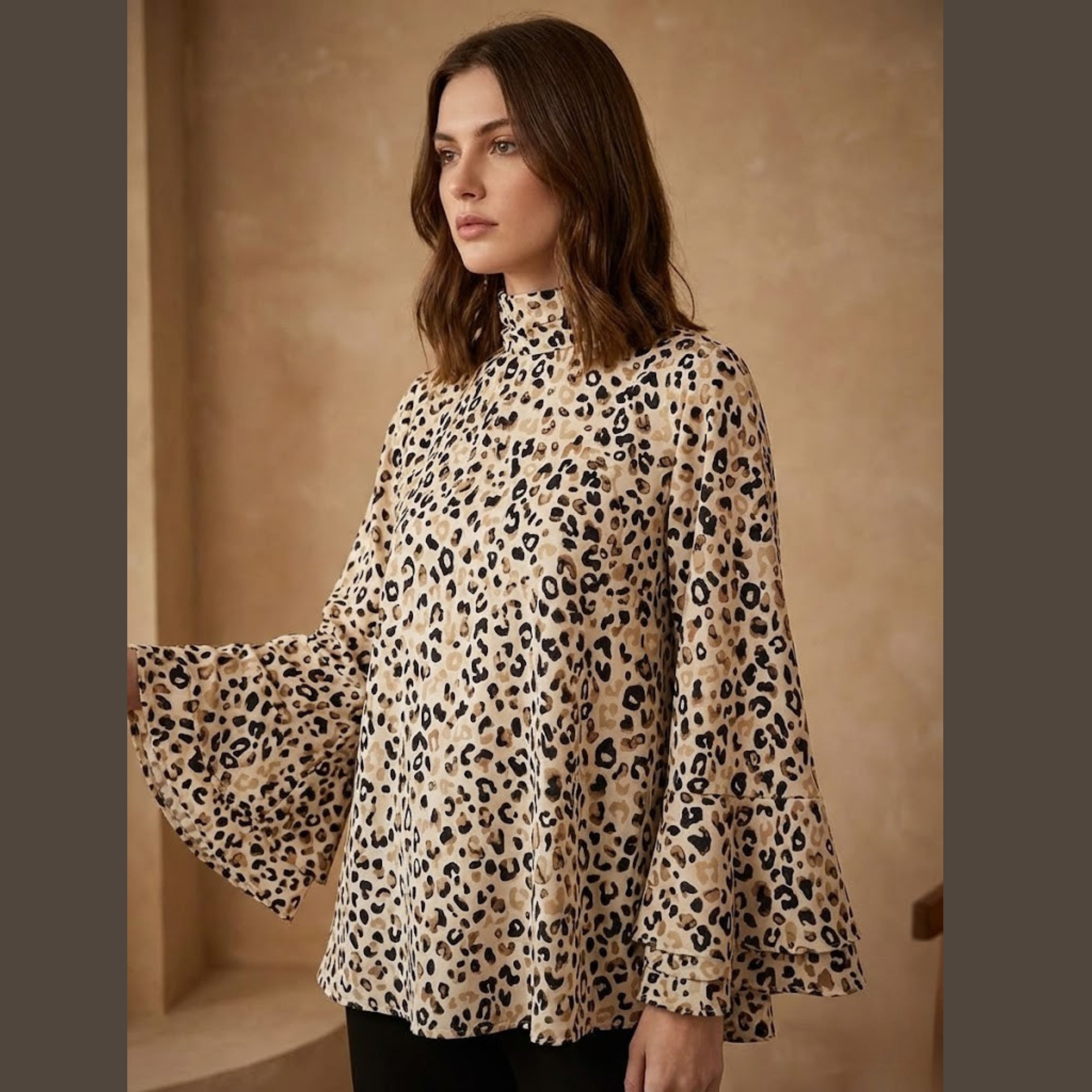 Woman wearing a leopard print blouse against a beige background