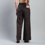 Plaid pants worn by a person on a gray background