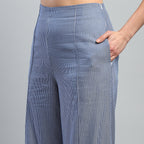 Blue checkered pants worn by a person on a gray background