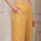 Person wearing yellow and white patterned pants against a neutral background