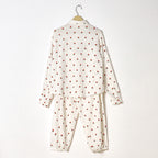 White pajama set with red polka dots on a white background