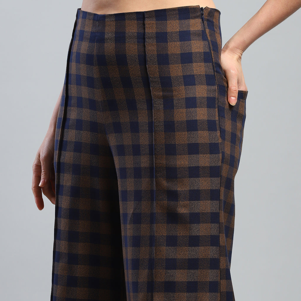 Plaid pants worn by a person on a gray background