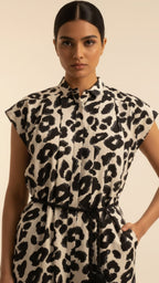 Woman wearing a leopard print dress against a beige background